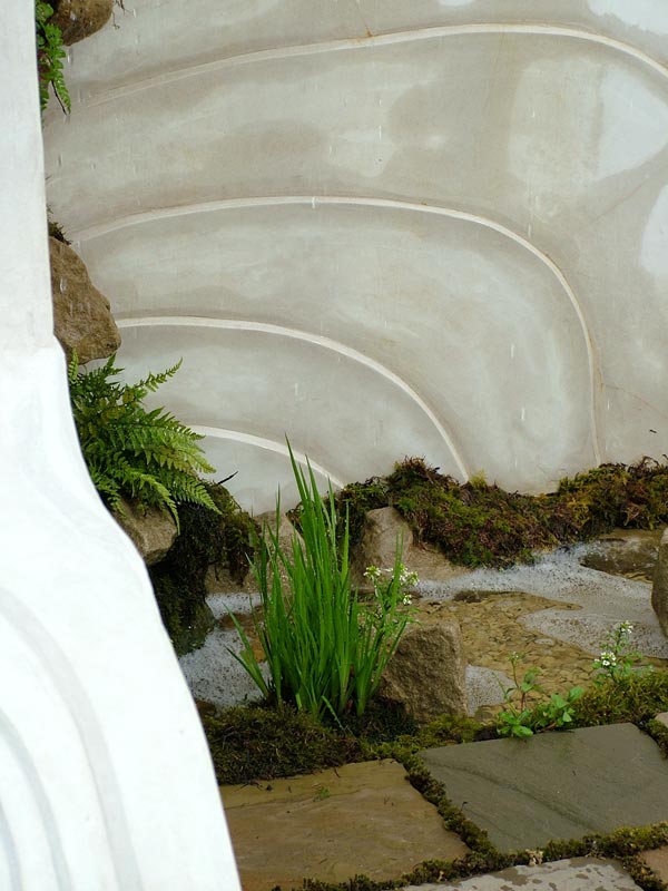  The rain-chain feeds water down to the stone stream. Can you see the darker gravel stream emerging on the bottom right? 