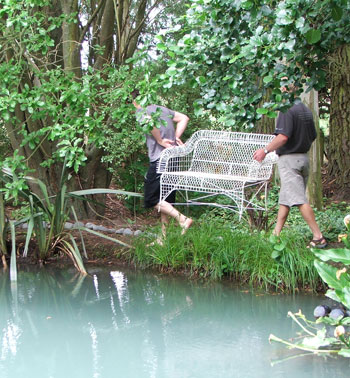  My two helpers are carrying the new seat behind the pond. 