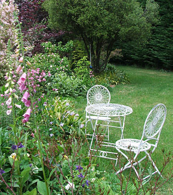  By the white garden furniture. 