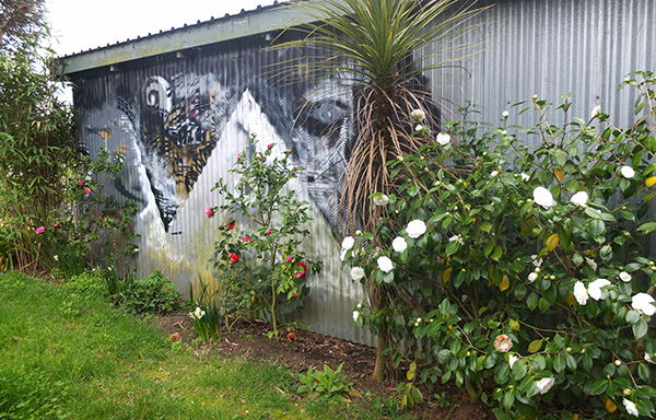  In front of the garden mural. 