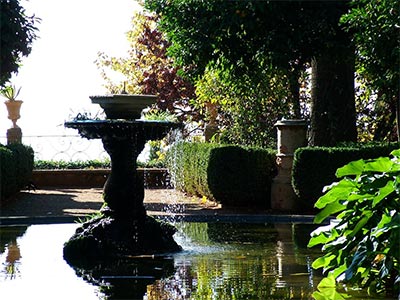  A sunlit spanish fountain photographed in the Carmen of the Martyrs Garden in Granada, Spain. 