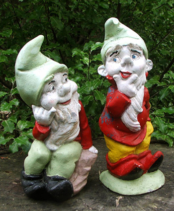  Two cheeky gnome chaps atop a tree stump 